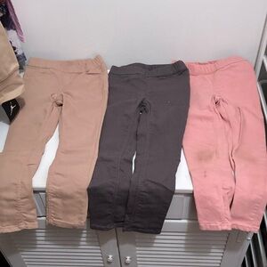 H&M 4T set of three pair of pants. Pink, grey and khaki. Pink has wear at knees
